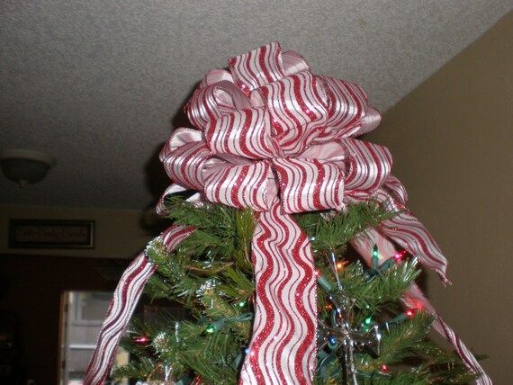 red and white striped tree top bow