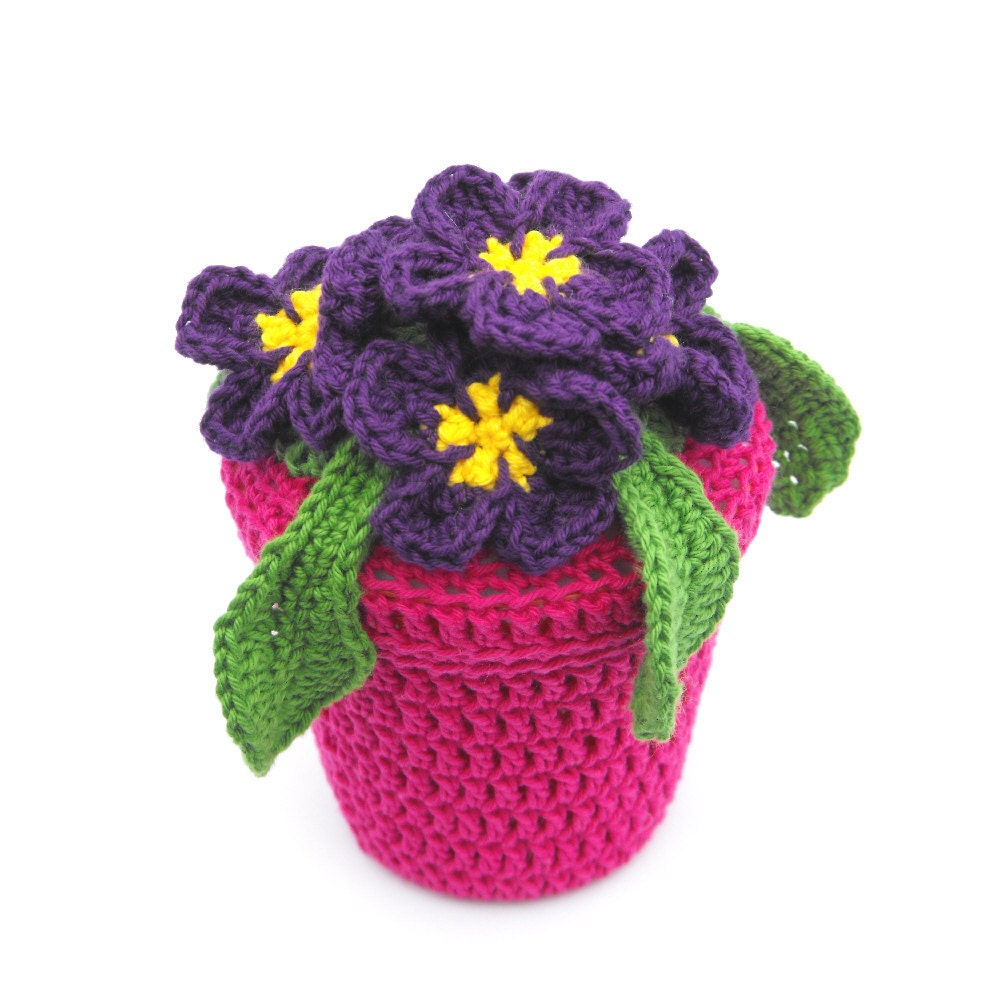 Unusual gift of Violet fake flowers in cerise pink pot
