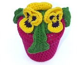 Yellow and violet Crochet Pansy flowers in hot pink pot