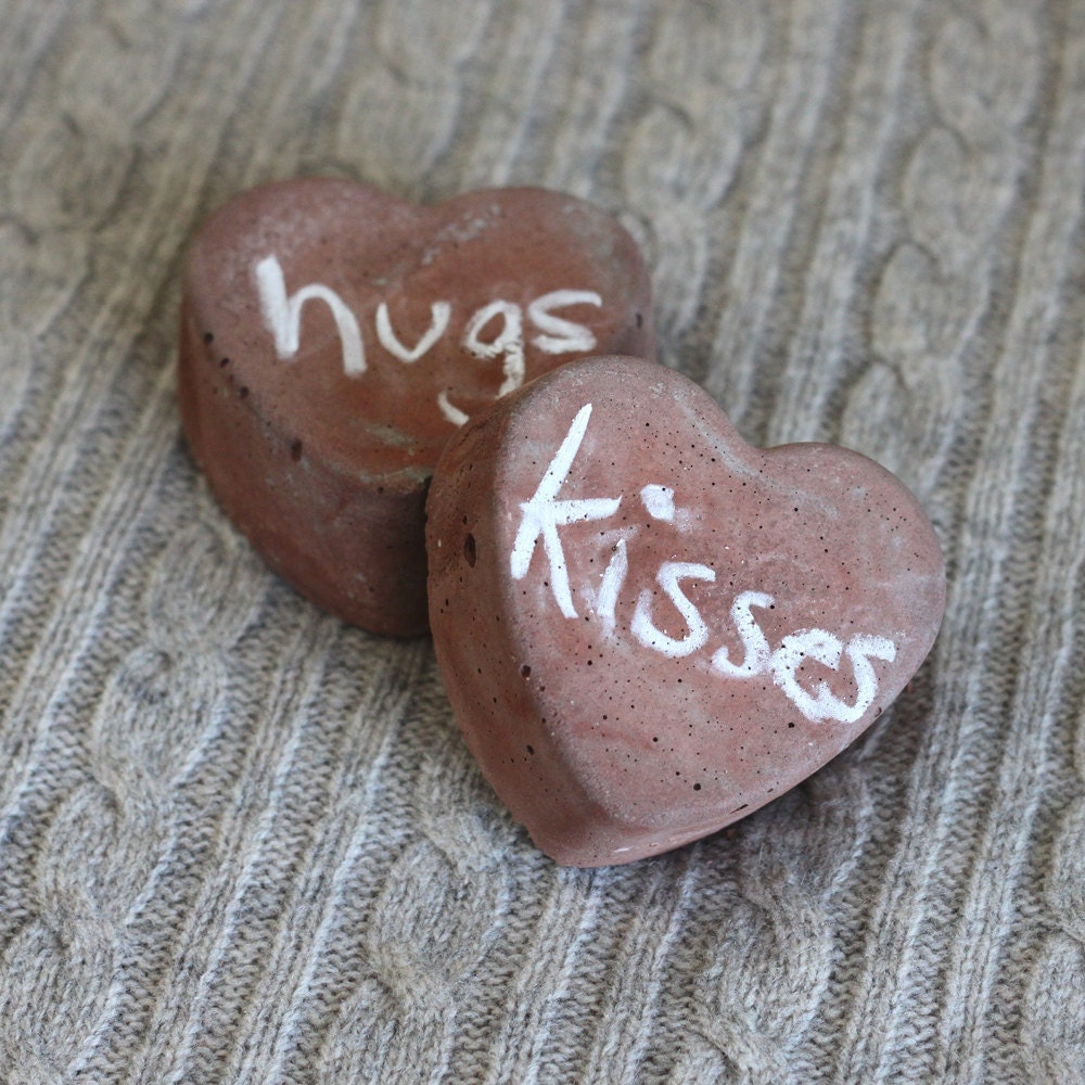 two red heart decorations, molded cement