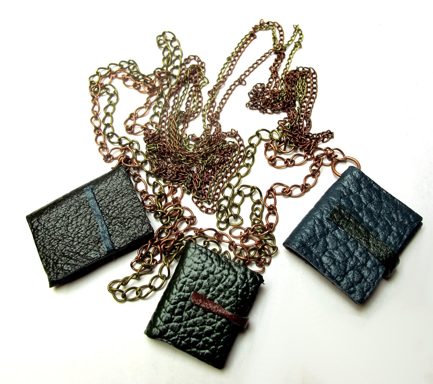 Book necklace, three decorative leather journals on chains.