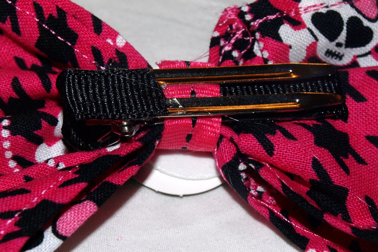 pink and black houndstooth and skull hair bow
