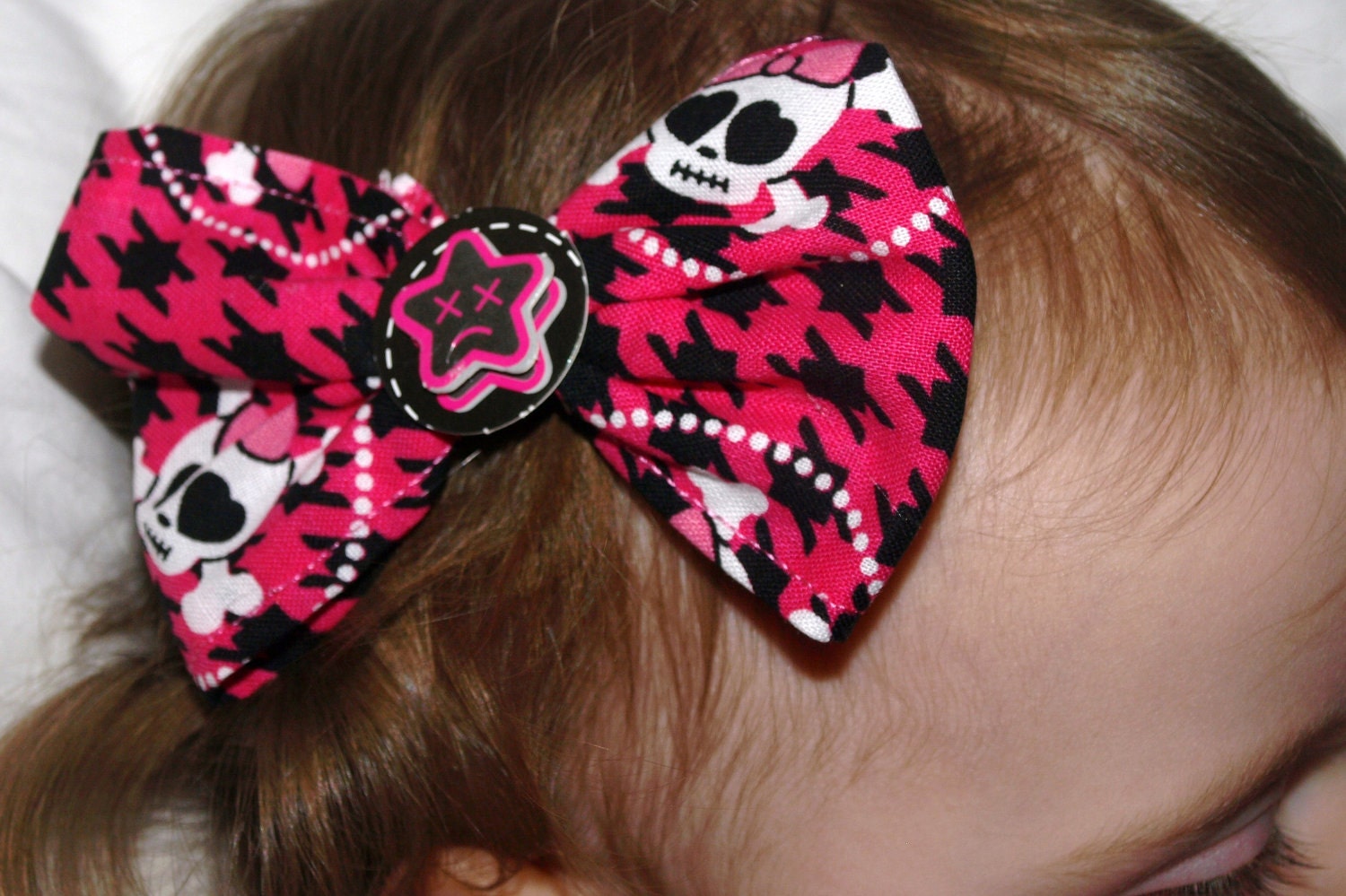 pink and black houndstooth and skull hair bow