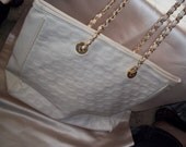 Large off white handbag with circular designs and zip top