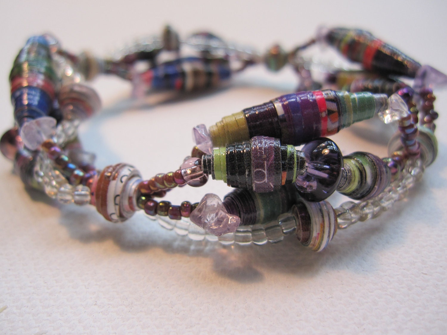 Colorful bracelet made with paper beads crafted from magazine pages