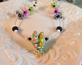 Lampwork Necklace with Heart Pod glass bead by Desert Bug in green with multi details and crystals