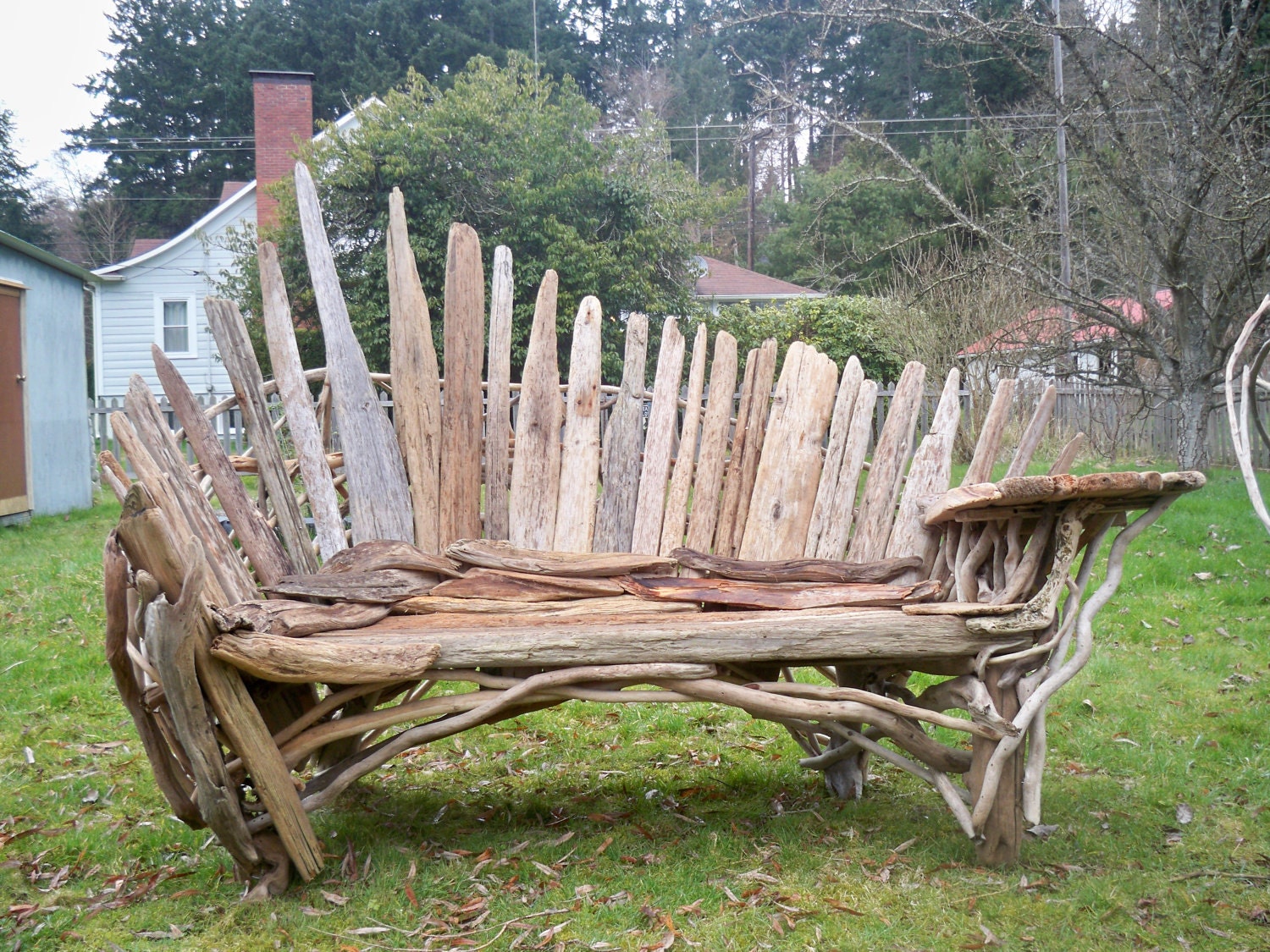 fan back bench with table built on. made from driftwood.