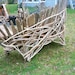fan back bench with table built on. made from driftwood.