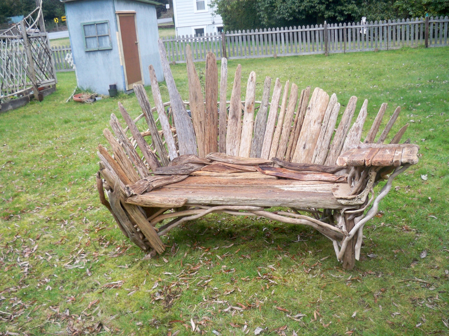 fan back bench with table built on. made from driftwood.