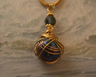 Brass Wire Wrapped necklace With Irridescent Blue & Purple Sphere and Blue Faceted Beads.
