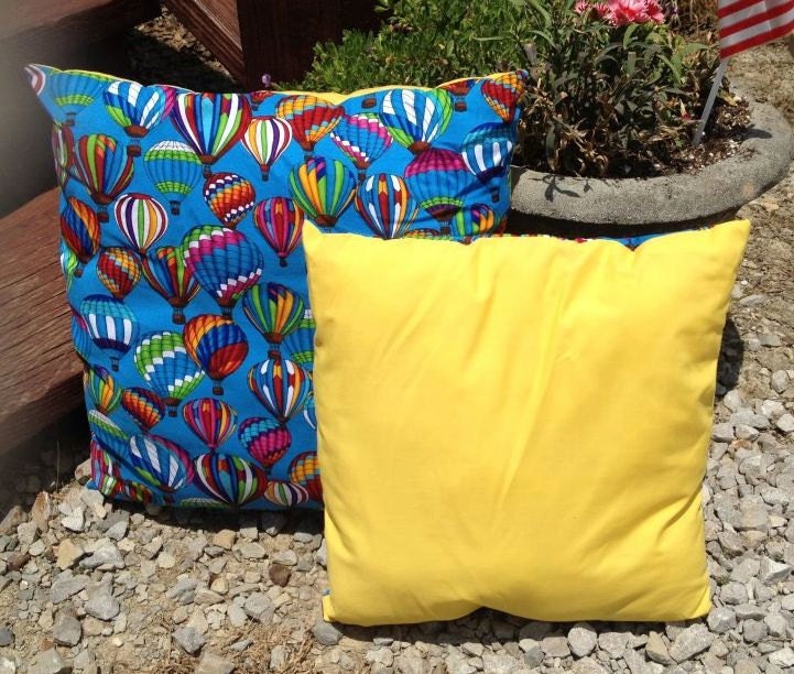 Two pillows small and large  hot air balloon pillow with yellow backing. comes in 2 sizes