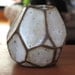 Faceted brown and white vase.