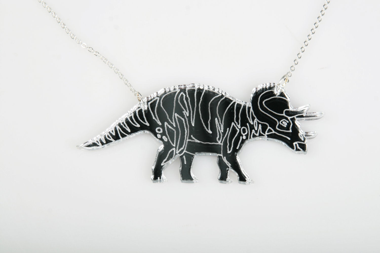 Triceratops Necklace. Laser Cut Acrylic Dinosaur Necklace. Mirrored Perspex and Cherry Wood.