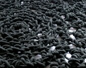 large crocheted doily rug in chunky black cotton cord