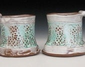 pair of mugs with white and green slip on circle texture