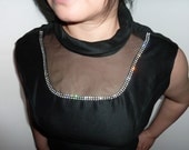 Sexy 60's sleeveless dress with organza panel and rhinestones accentuating bust. Little black dress.