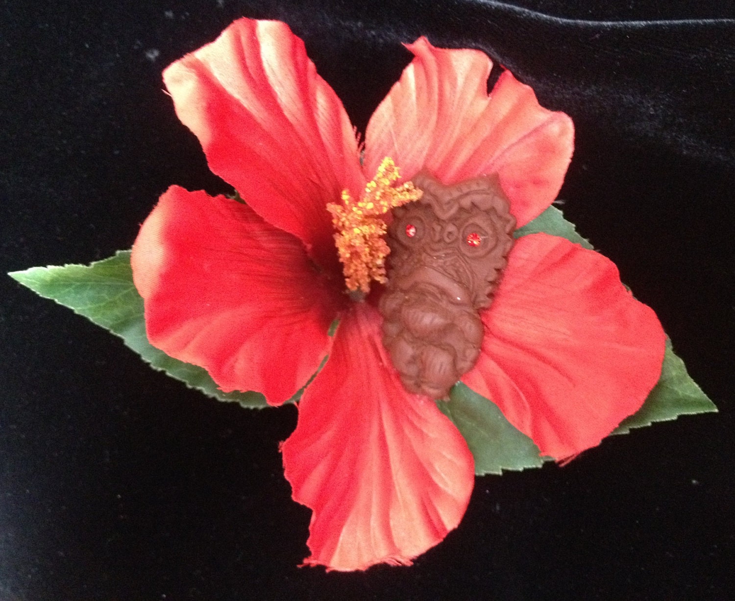 Tiki God on a silk hibiscus flower hair clip