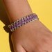 Leather like cord and chain braided bracelet, silver and purple.