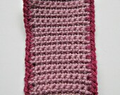 Crocheted iPod cover in pale pink with a dark pink trim