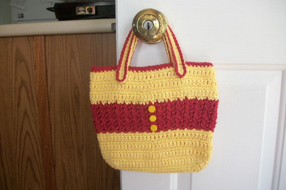 Crocheted tote bag of red and yellow cotton yarn with yellow button accents