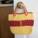 Crocheted tote bag of red and yellow cotton yarn with yellow button accents