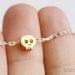 tiny skull bracelet - matt 14k gold plated skull on WHITE and golden chain