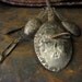 Peruvian Spoon Shawl Pin with Milagros Charms and Green Glass Bead - vintage hand-hammered silver brooch from 1920s
