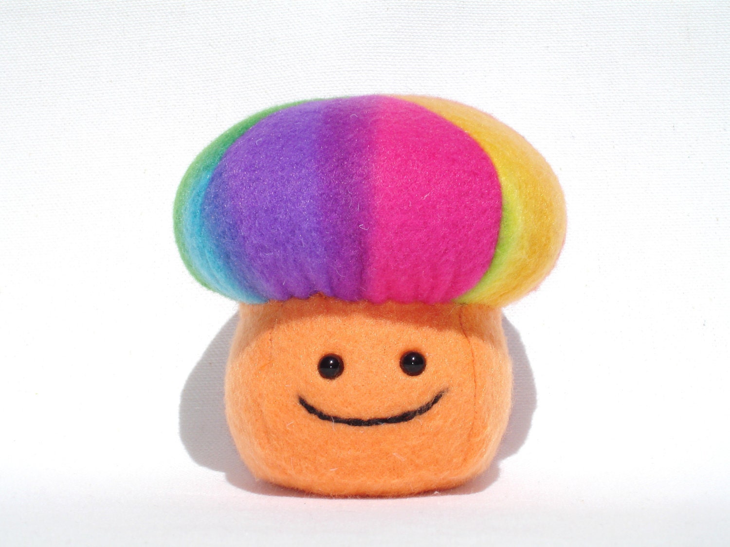 Plush rainbow mushroom toy made with orange and rainbow fleece