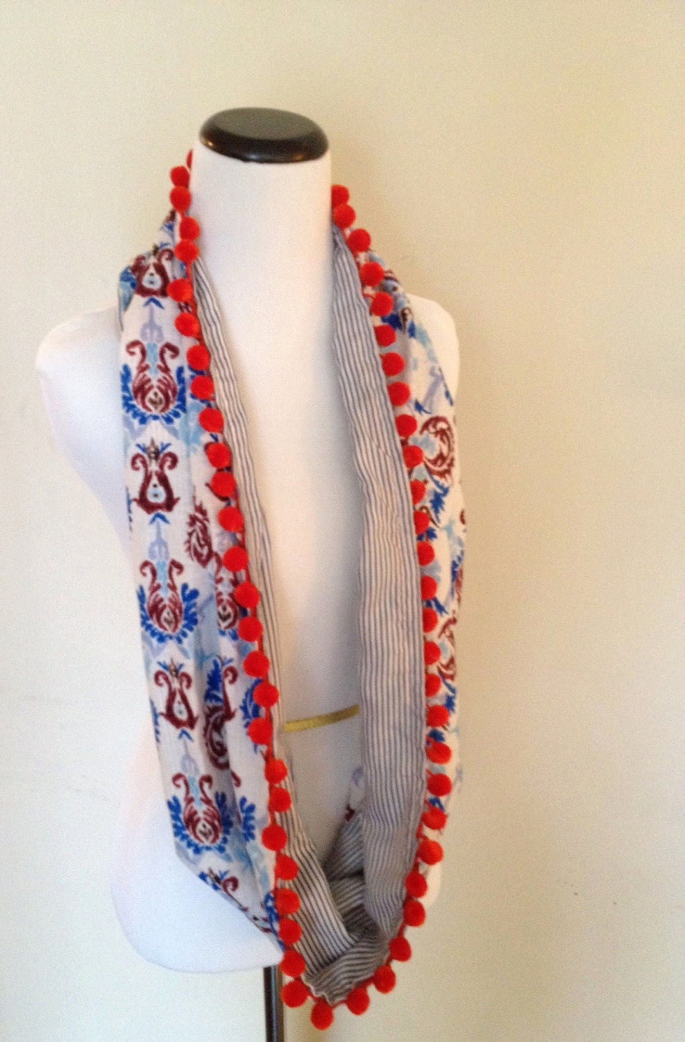 Infinity Circle Scarf with pom pom accents.