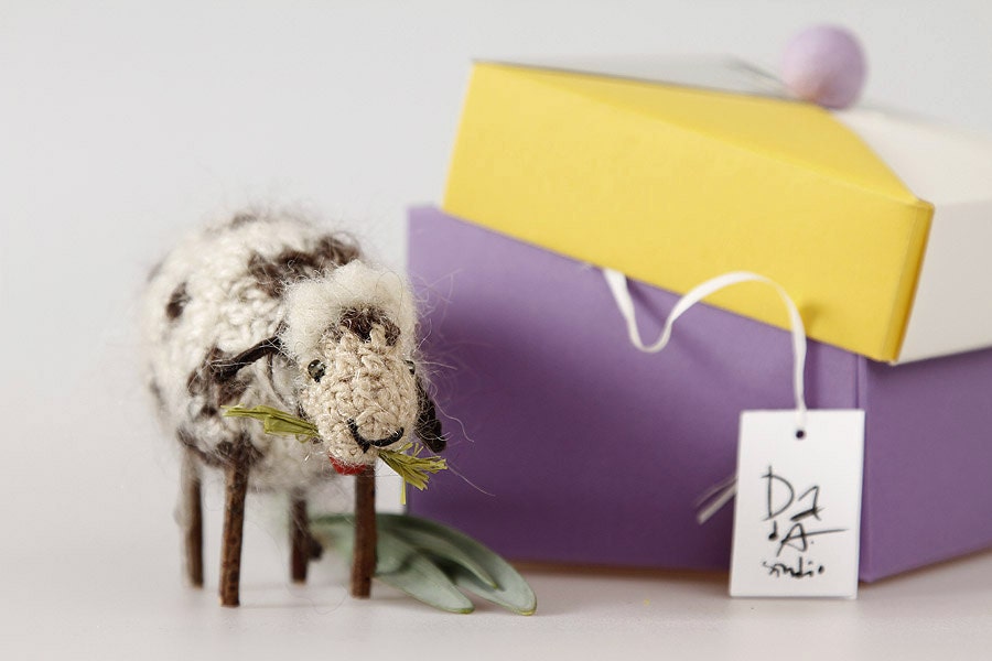 Small sheep made from wool decorated with beads, wood and tinkler