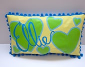Baby pillow in light yellow, lime green and cool blue. Personalized with name.
