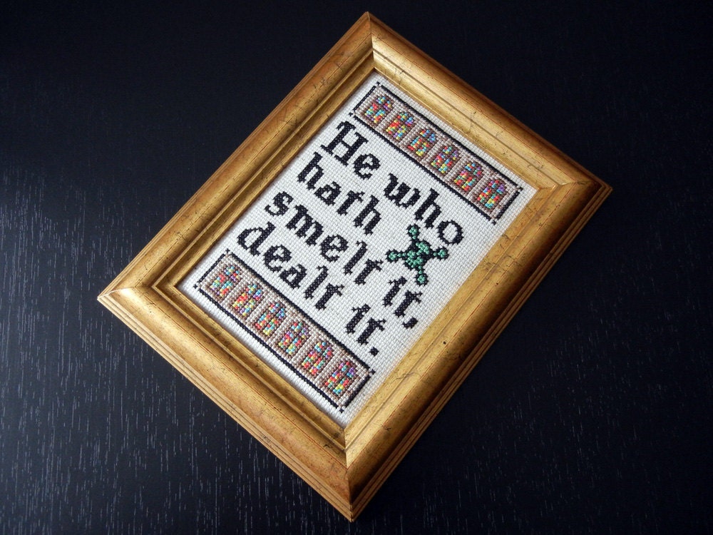 Text Framed Cross-Stitch: He who hath smelt it, dealt it.