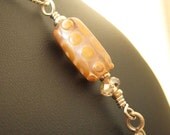 Soft pink and yellow gold glass bead and crystal with silver spiral charm