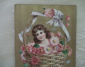 Pretty Girl in a Basket of Flowers - Vintage Embossed Postcard - gilded gold - early 1900's