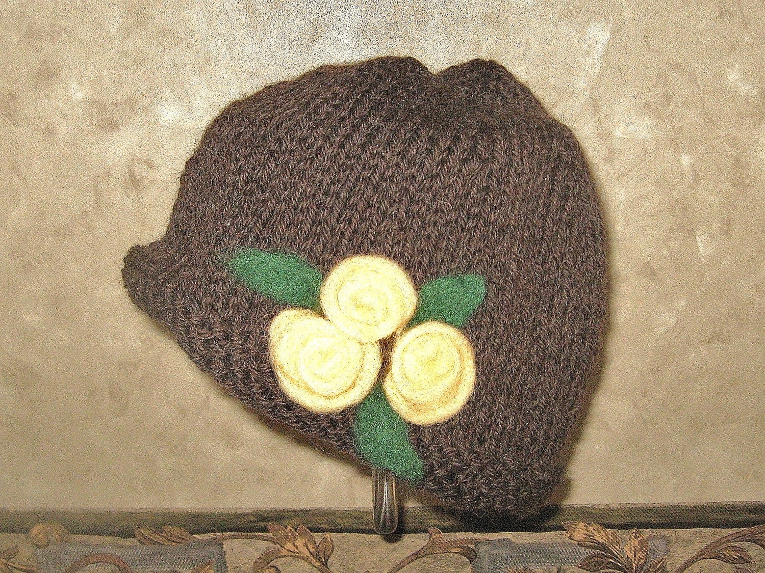 Hat knit with needlefelted yellow roses
