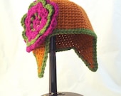 Pointed Baby Hat with Earflaps in Pumpkin Spice with Magenta and Olive Green Oversized Flower