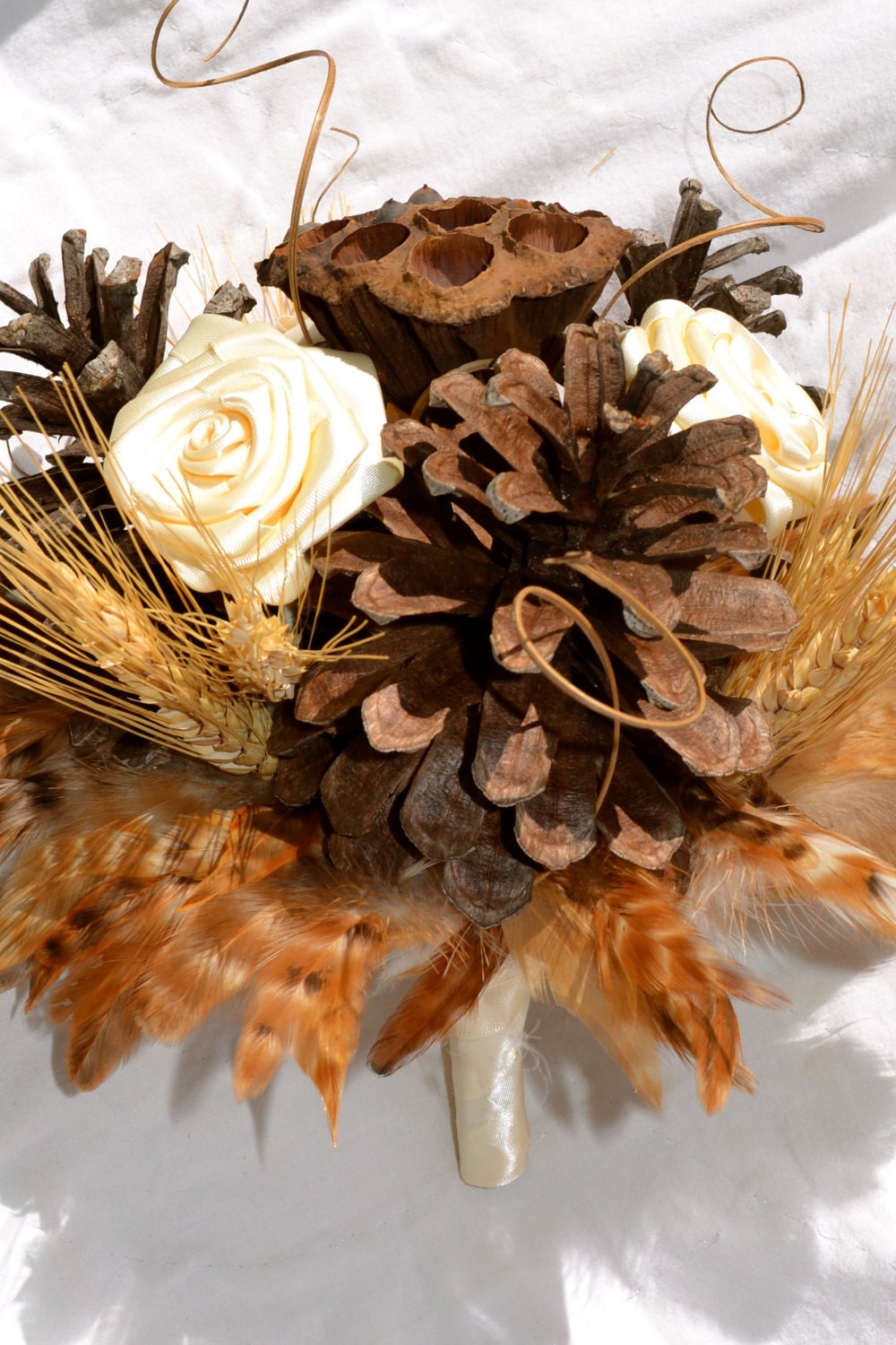 Rustic Natural Bridal Bouquet with pinecones, fabric flowers, wheat, lotus pods, and feathers