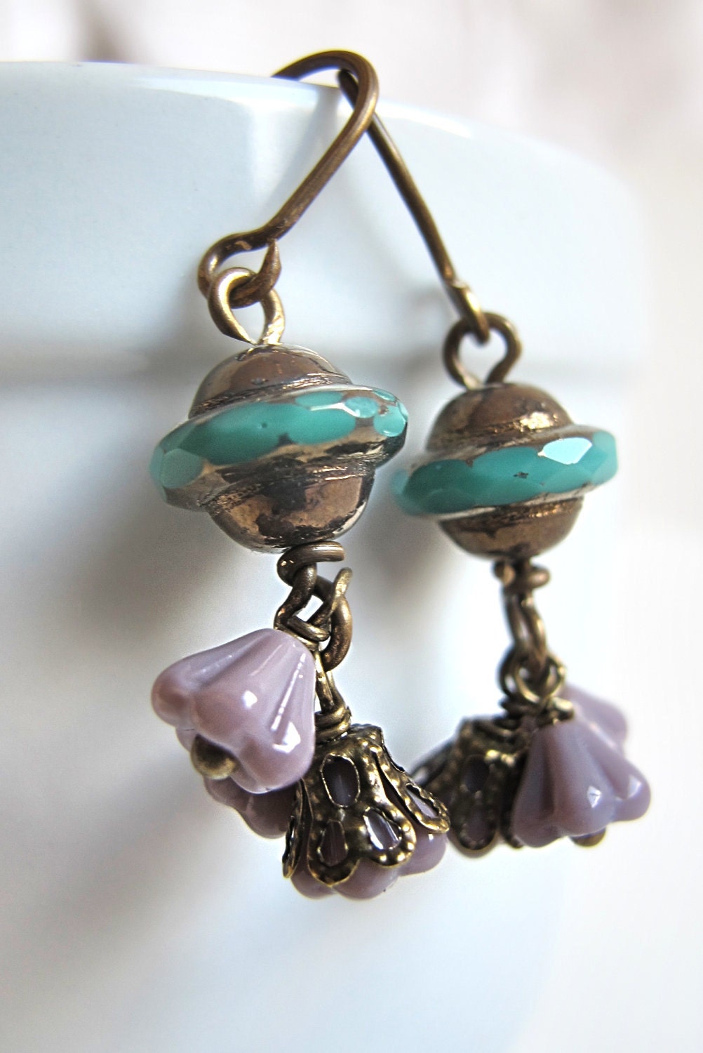 tender purple green blue flowers and beads in glass with brass