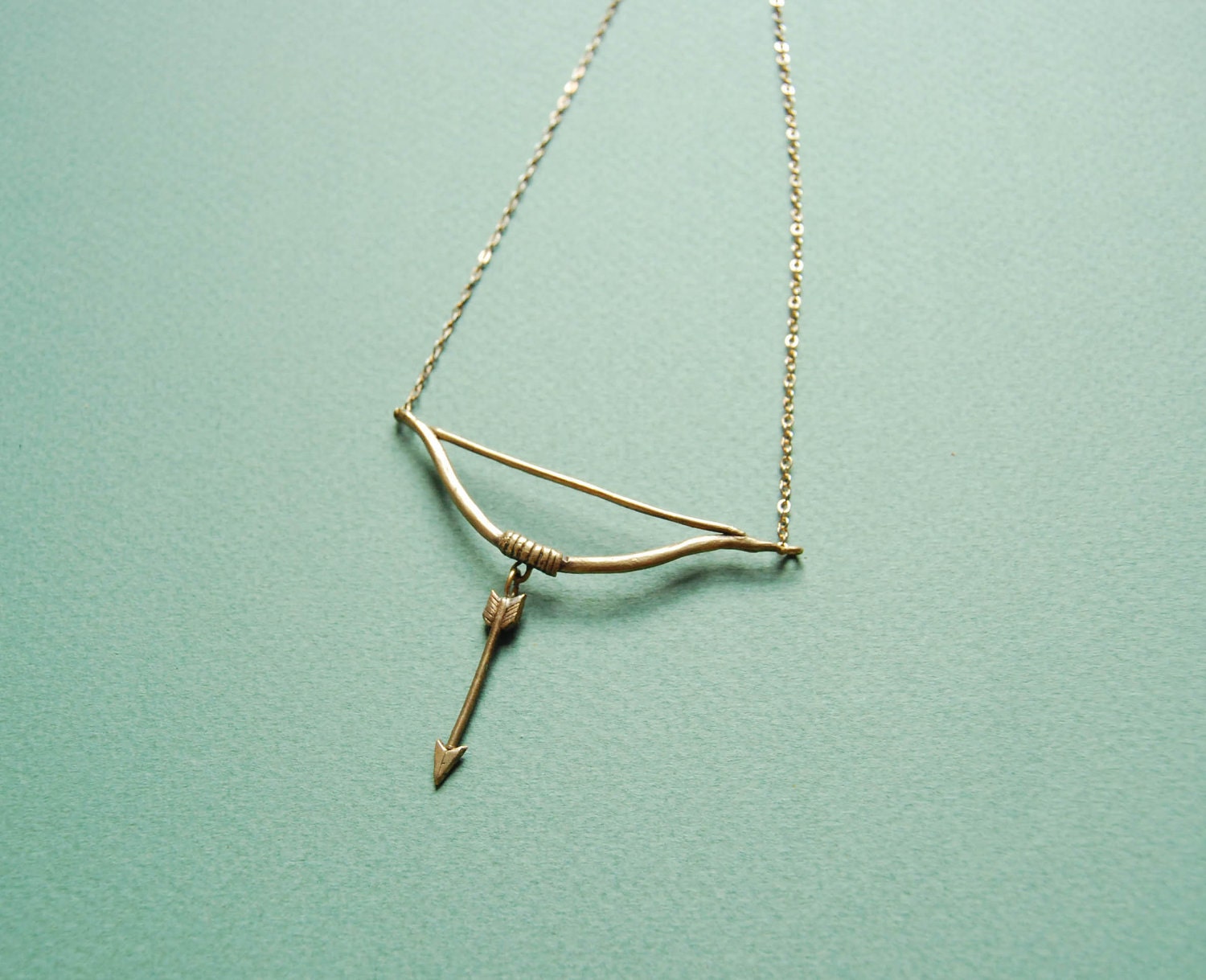 Golden bow and arrow necklace