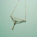 Golden bow and arrow necklace