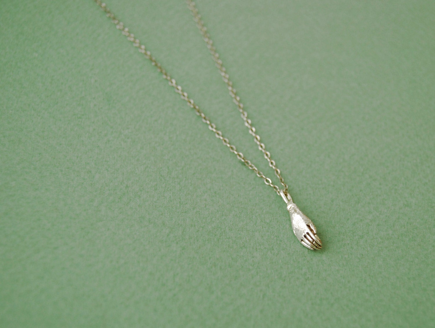 Tiny hand necklace in silver