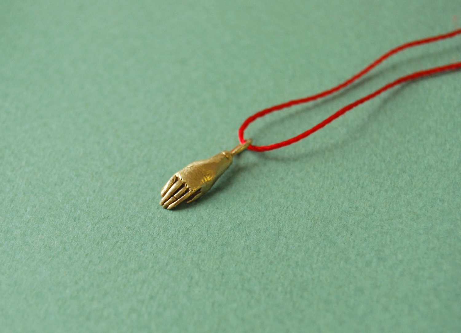 Golden hand on red silk