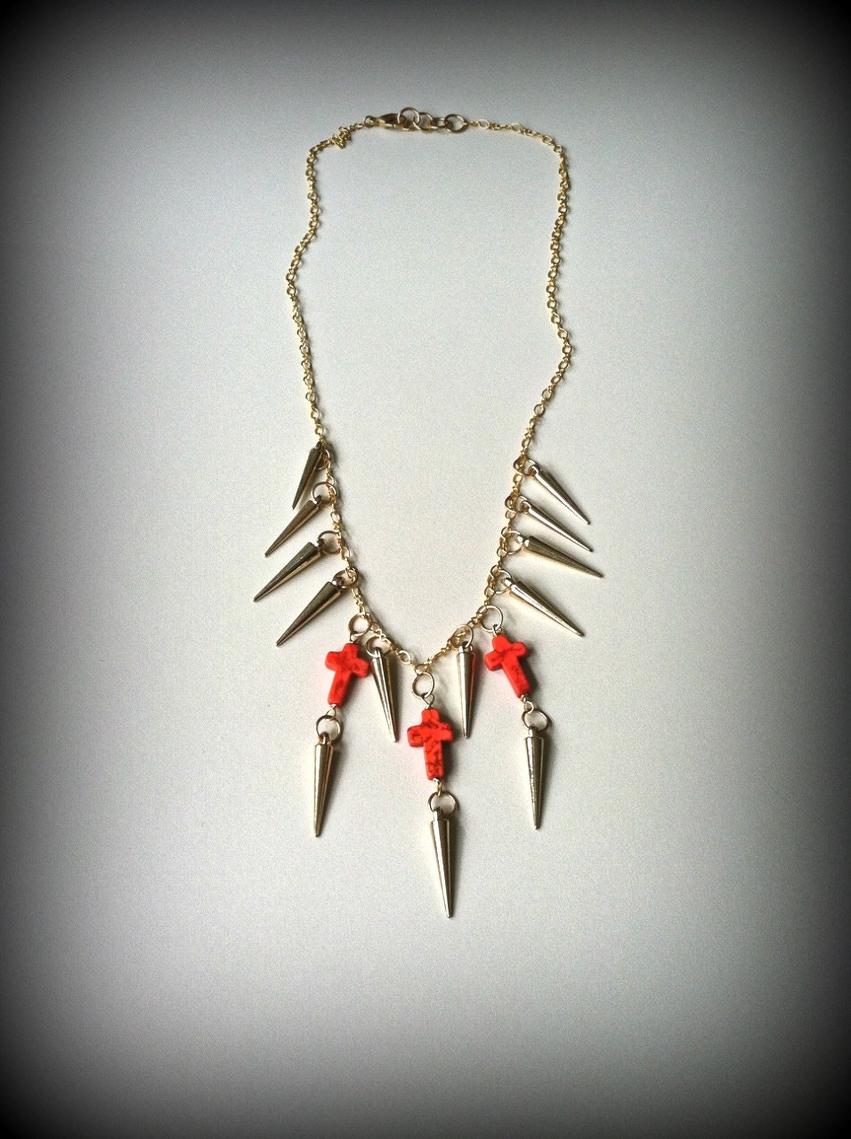 Gold Spiked Iron Maiden Necklace with Orange Crosses