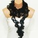 The scarf is knitted with black, soft yarn. Long scarf. Romantic. For her. HAND MADE.