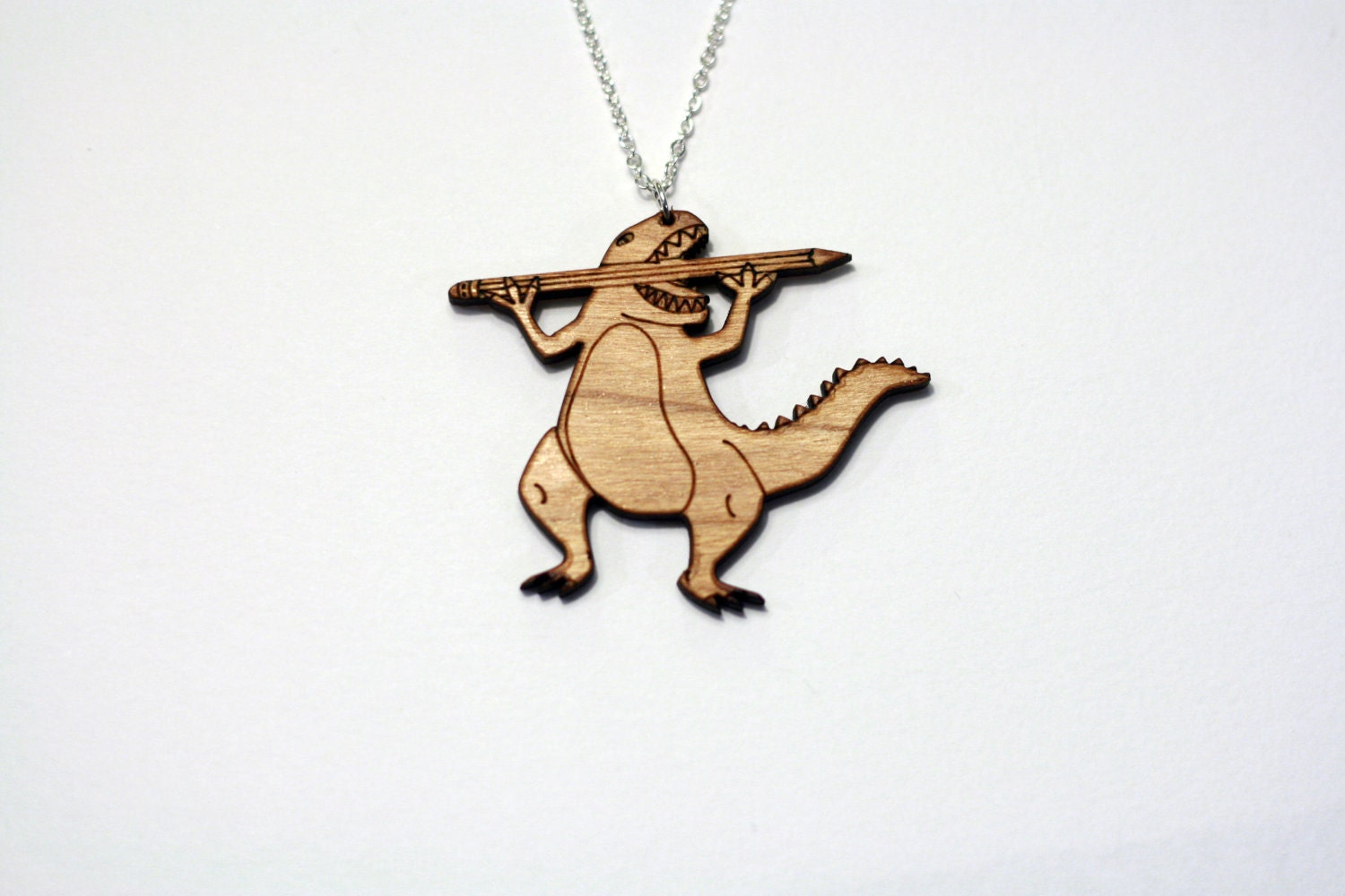 Designosaur Necklace. Laser Cut Wooden or Acrylic Dinosaur Necklace. Cherry Wood or Perspex.