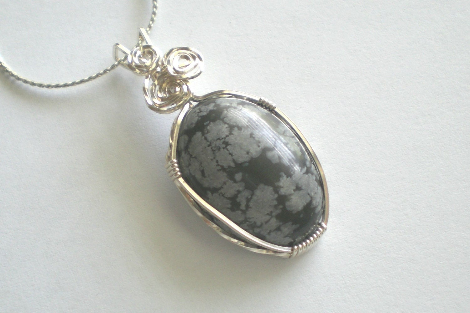 Snowflake Obsidian oval wire wrapped in sterling silver pendant