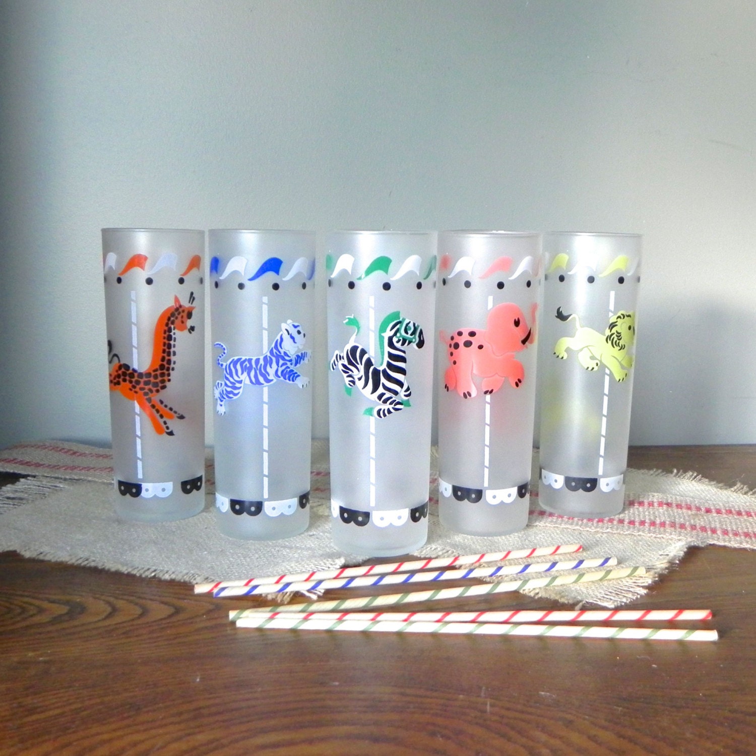 Vintage colorful Libby glasses animals on a carousel circus with five vintage wax straws tall glasses