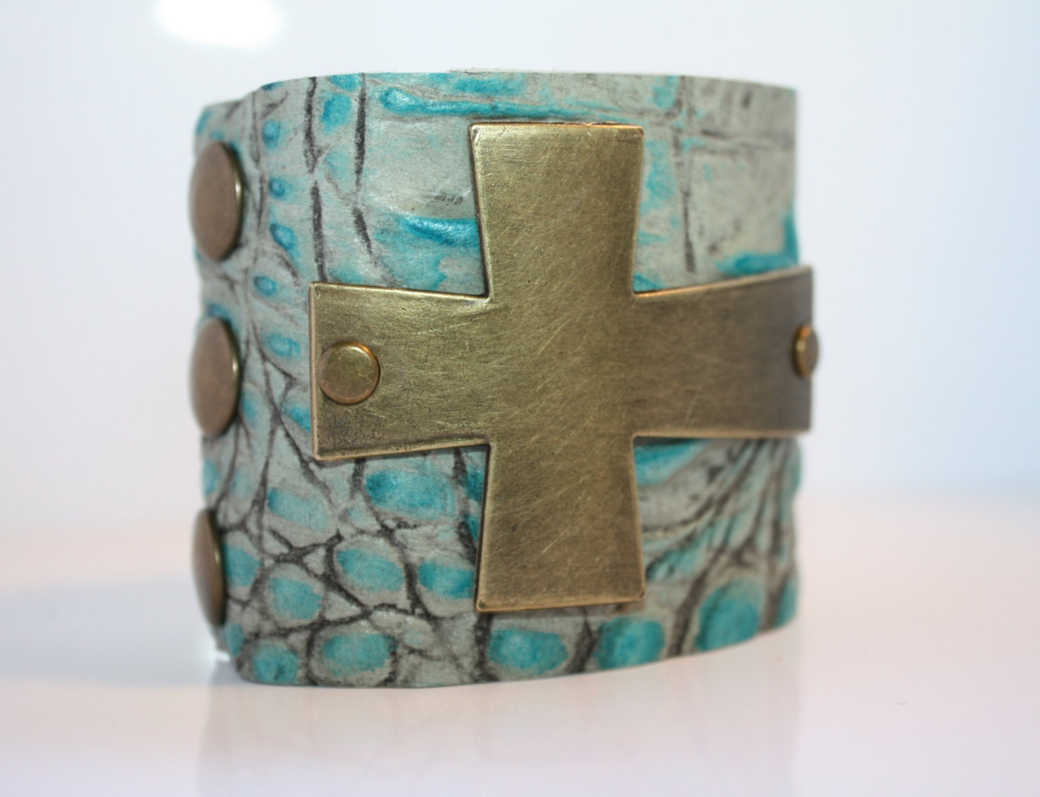 Sideways Antique Brass Cross on a Turquoise Croc Embossed Leather Cuff