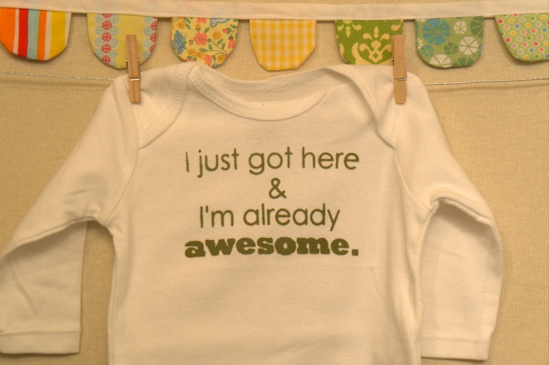 I just got here & I'm already awesome.  --- white long-sleeved onesie, size 0-3 months.