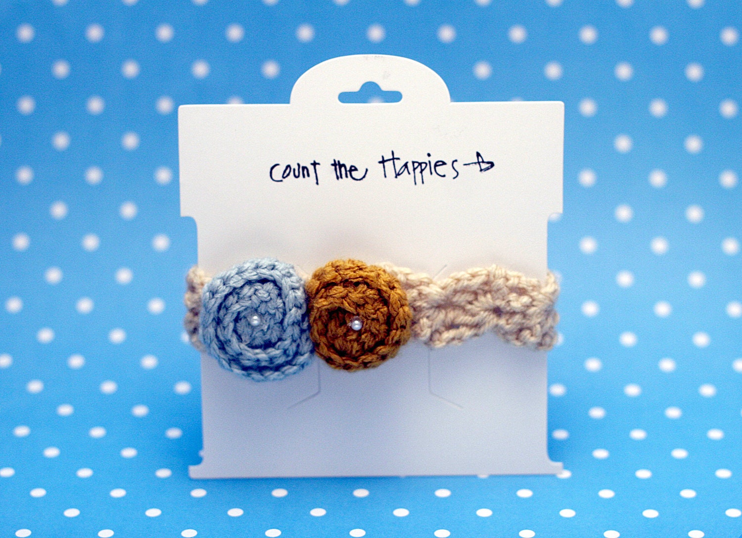 Crochet Baby Headband in Beige with Blue and Gold Rosettes